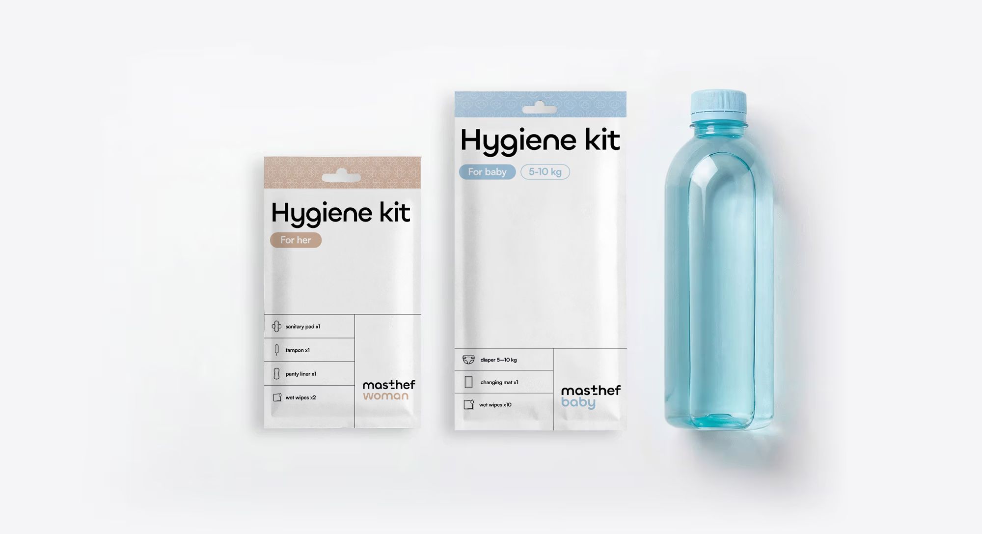 Two masthef hygiene packs – woman and baby – beside a bottle of water against a light background